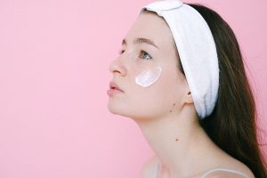 Calm woman with face cream