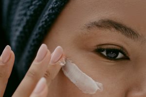 Woman applying Facial Cream on Face