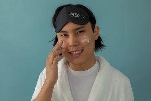Man Putting Cream on Face