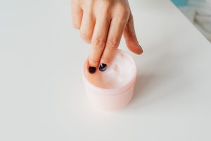 Fingers Picking up Cream From Container