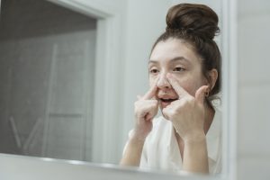 Young Woman Washing Her Face in the Bathroom