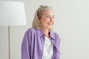 An Elderly Woman in Purple Long Sleeves Smiling
